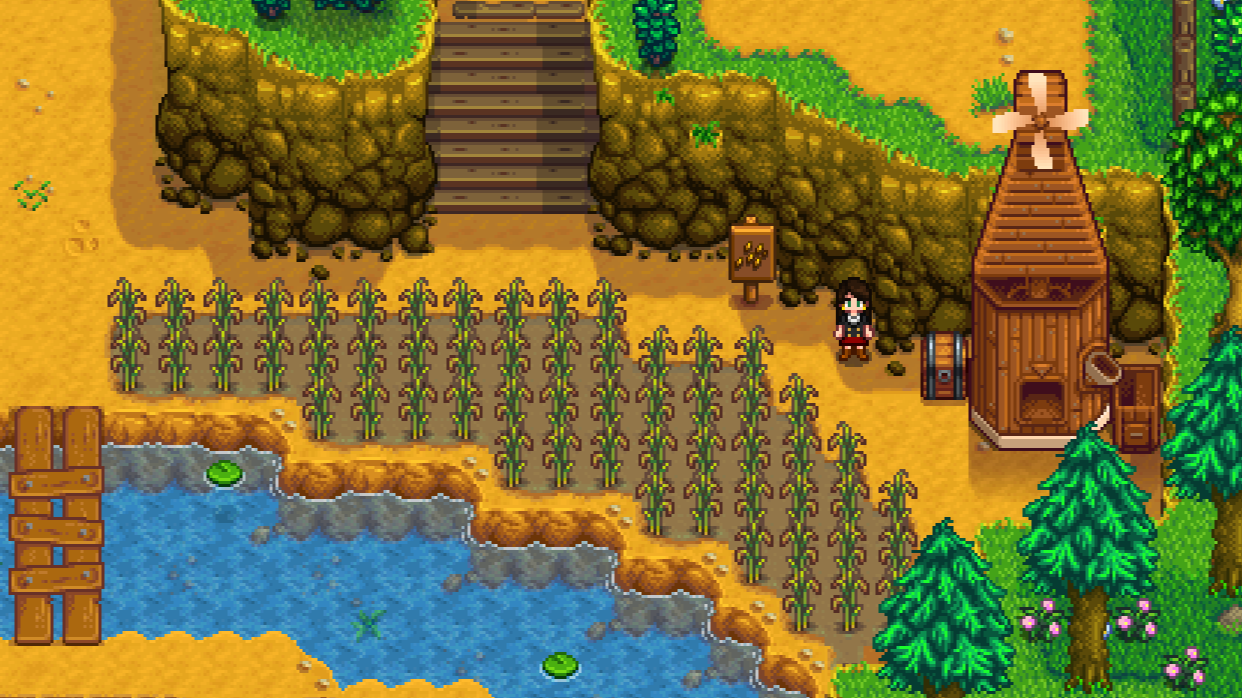 Mill in Stardew Valley near a field of rice crops