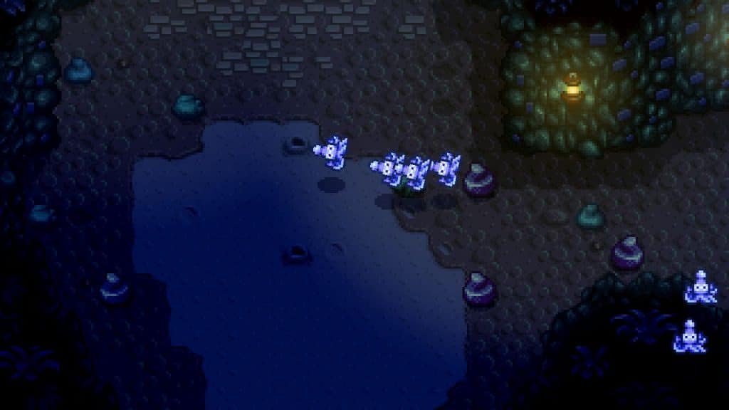 A group of Blue Squids "swimming" in the air towards the player in Stardew Valley.